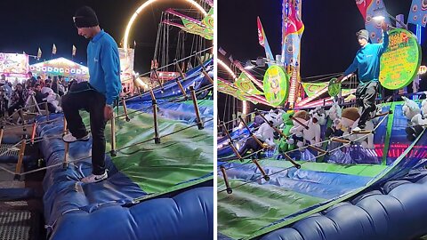 Talented Guy At Carnival Climbs Ladder Backwards To Win Prize