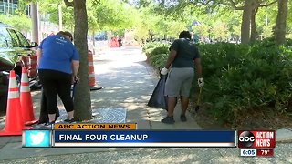 Volunteers clean along Rverwalk in preparation for the NCAA Women's Final Four Championship