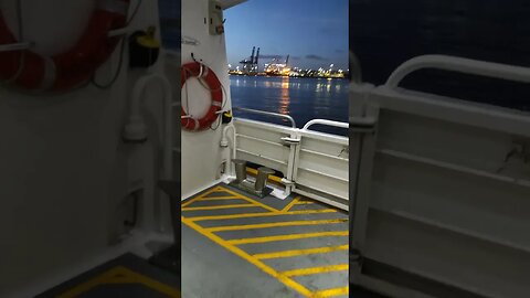 Ferry passes car carrier and tugboat