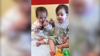 "Twin Baby Girls Argue Over Who Gets to Play with A Toy"