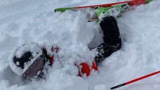 Guy buried head-first in snow after failed ski jump