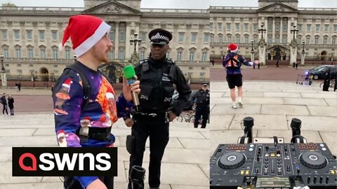 DJ blasts tunes outside Buckingham Palace as officers try to convince him he is breaking the law