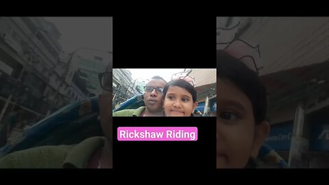 Father and daughter ride a rickshaw