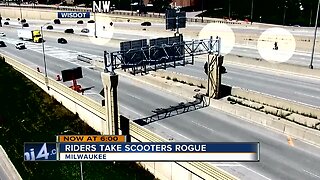 Texas men ride electric scooters on I-94