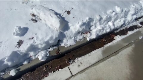 Several Aurora residents issued warnings over icy sidewalks, say drainage system is to blame