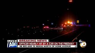 Officer nearly hit by car on 805 freeway