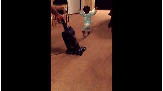 Baby girl runs to escape evil vacuum cleaner