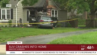 SUV crashes into home
