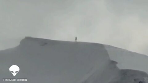 A giant humanoid figure filmed on top of a mountain in Canada. Witness claims to be stalked by CIA.
