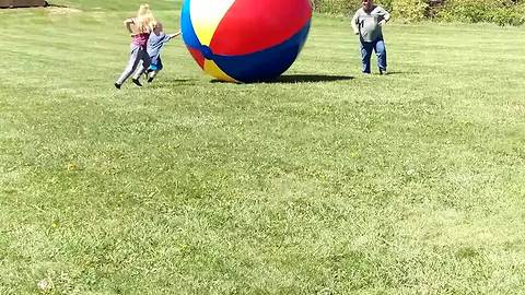 Dad Kicks Giant Ball Into Kids and Knocks Them Over