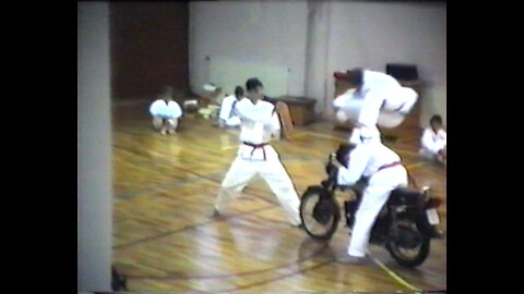 Taekwondo flying kick over motorcycle