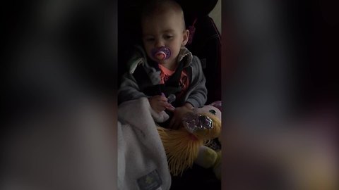 A Baby Girl Alternates Between Two Pacifiers