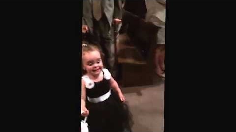 Precious Flower Girl Sees Dad While Going Down The Isle, Stops To Say Hi