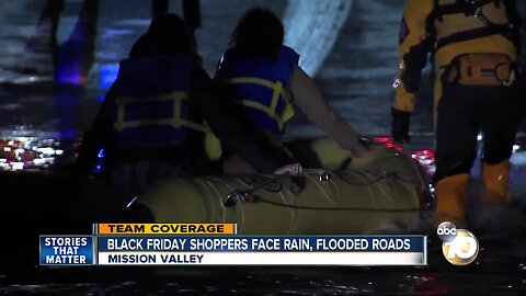 Shoppers rescued after driver gets stuck in flooded street