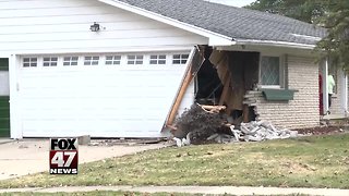 Car crashes into house in South Lansing