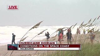 High waves from Hurricane Dorian bring people to the beach in Melbourne