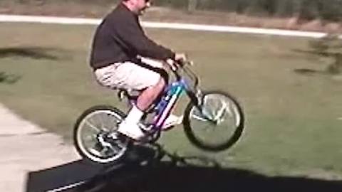 Dad Fails At Showing His Kids How To Ride On A Bike Ramp