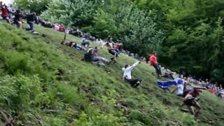 People throw themselves down a hill for... cheese!