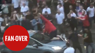 Football fan climbs on board MOVING car to celebrate England's world cup win