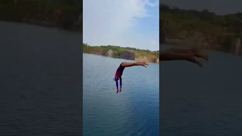 Chinese Girl Cliff Dives From A Piked Position