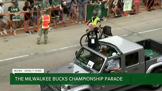 Gov. Evers throws up 'W' hand symbol during parade