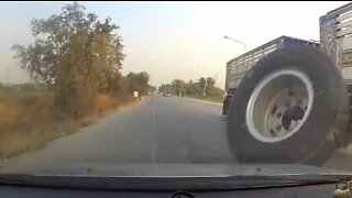 Wheel jumps off a truck and collides with a car
