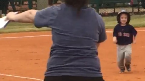 A Confused Baseball Playing Little Boy Runs To Give Mom A Hug