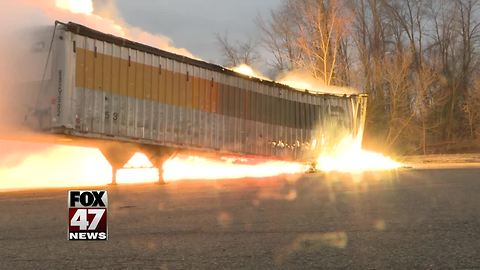 Crews monitor trailer fire burning at Mid-Michigan business