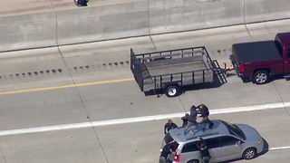 Watch as police tackle a chase suspect on top of a car