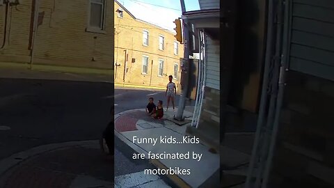 Riding a motorcycle through a covered bridge, and entertaining some kids with some revs.