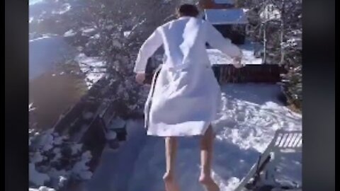 Man Sips Coffee And Jumps Into A Pile Of Snow