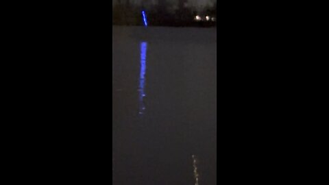 Mysterious blue object, emitting a glowing light, was spotted in the sky and descends into river