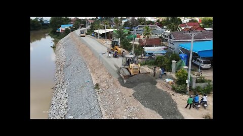 New road building on dike mighty Machines bulldozer motor grader and roller