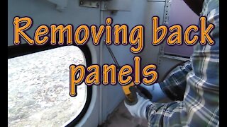 Removing back panels for bus conversion to RV.