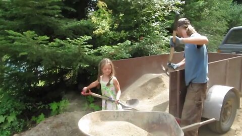 Girls helping daddy on the homestead