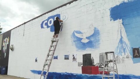 Master sign painter David Jones is working on a "Unity Mural"