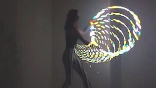 Talented girl performs incredible tricks with LED hula hoop
