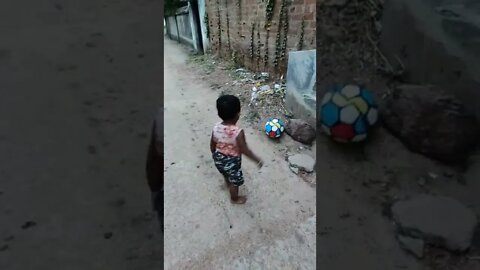 Baby playing with foot ball