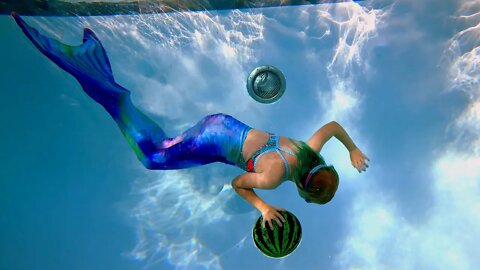 Mermaid Plays with Ball Underwater