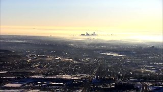 Low clouds clearing at sunrise in Denver