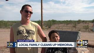 Family cleaning graffiti off historical memorial