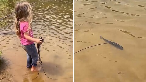 Little girl taking her pet fish for a "walk"