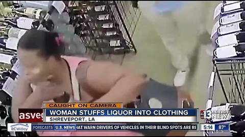 Woman stashes 18 liquor bottles on body