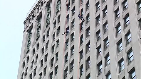 Ann Marie LaFlamme rappelling down a building