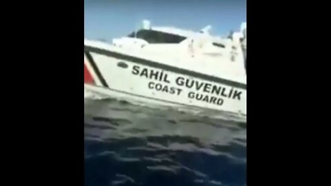 Turkish coast guard (Sahil Güvenlik) falls on a boat with migrants