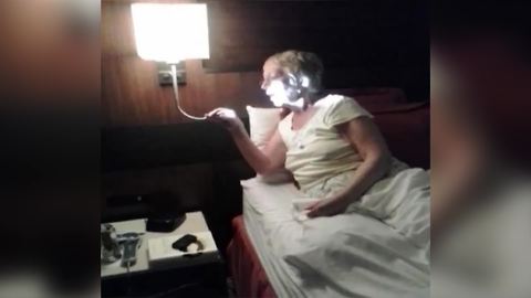Funny Woman Mistakes A Reading Light With A Room Service Mic