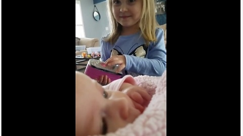 Toddler preciously makes her baby sister laugh