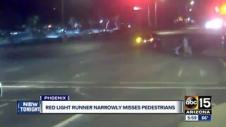 Red-light runner nearly hits family pushing stroller