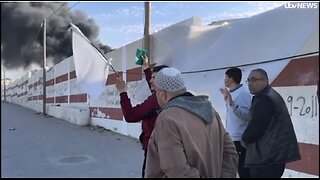 A civilian brandishing a white flag being shot dead by Israel military