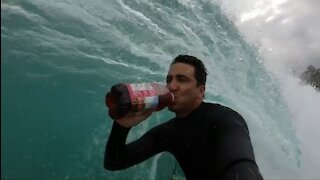 Surfer takes on viral trend and drinks cranberry juice on the waves